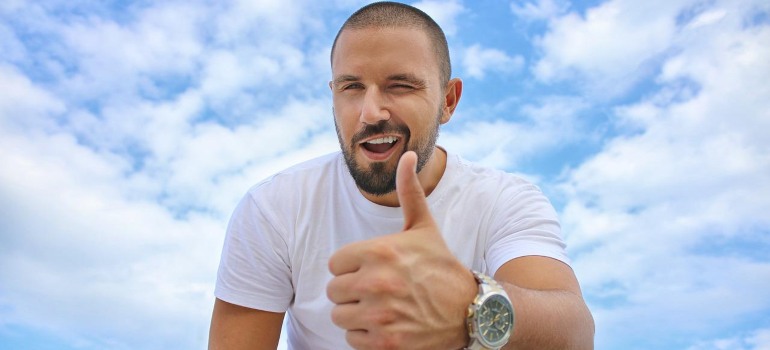 A man showing a thumbs up gesture.