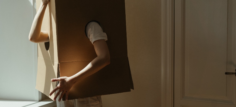 a person stuck in a big moving box
