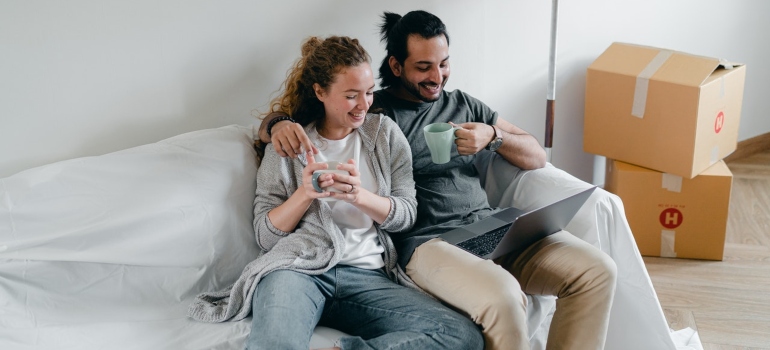 a couple considering what to buy when moving into a new home.