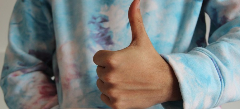 A person showing a thumbs up gesture.