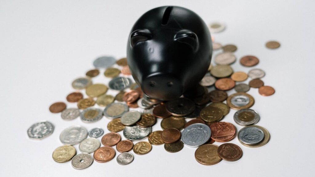 A piggy bank surrounded by coins.