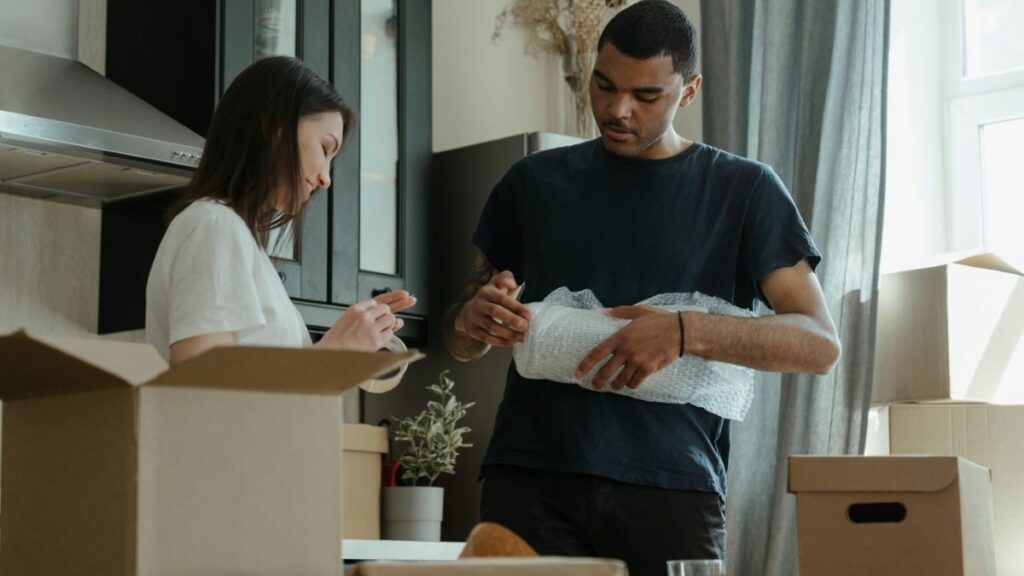 A couple packing for a move.