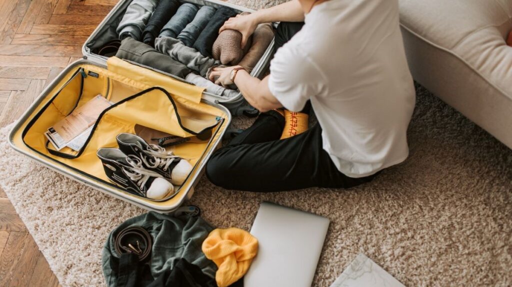 A man packing his suitcase for a trip.