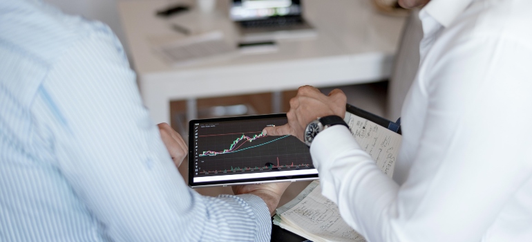 One man showing something on a graph to the other man.