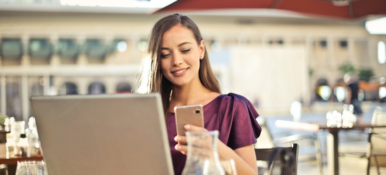 A woman looking at her phone and smiling.