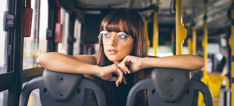 A woman sitting in a bus.