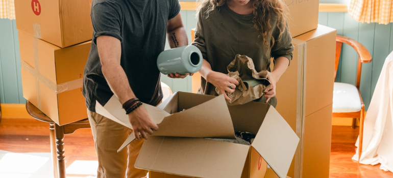 Man and woman packing a moving box