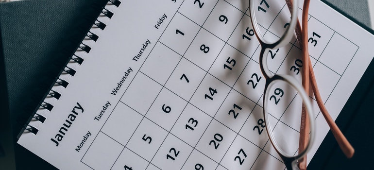 A calendar with the glasses on top of it.