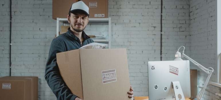 A man holding a box labelled 