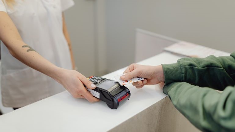 A person paying by a card.