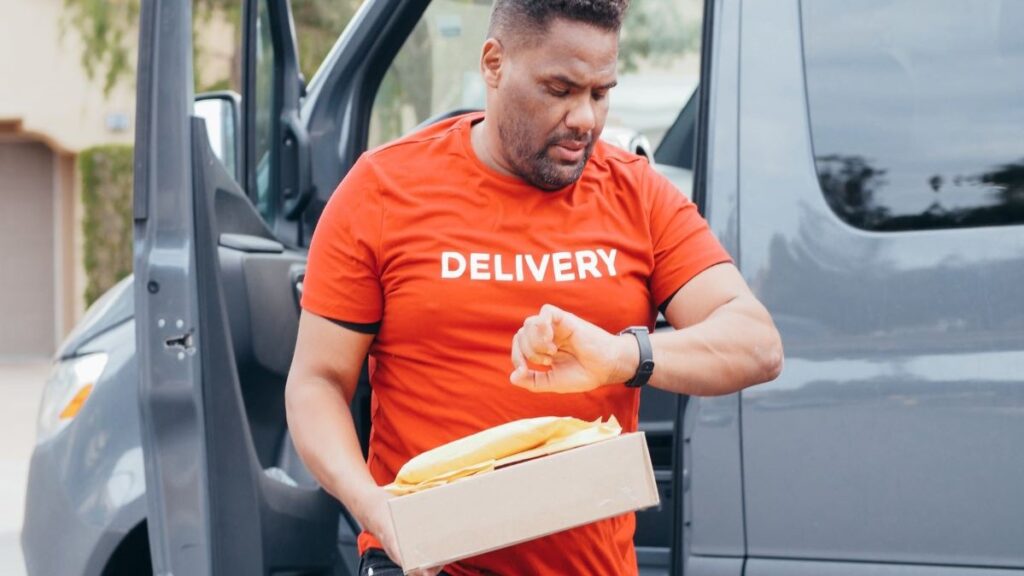 A delivery man checking his watch.