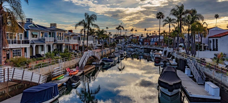 A photo of boats in Naples Island, Long Beach with the houses surrounding the water.