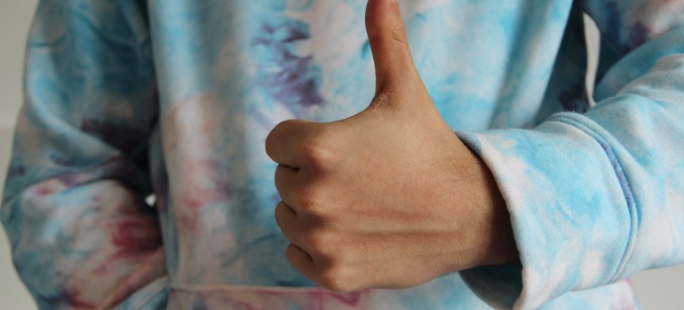 A person holding a thumb up