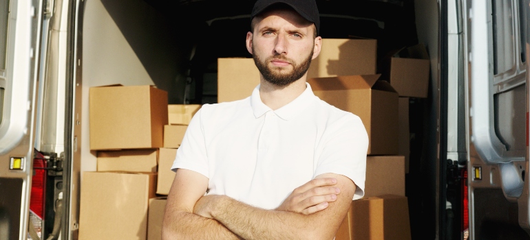 A man standing in front of a moving van