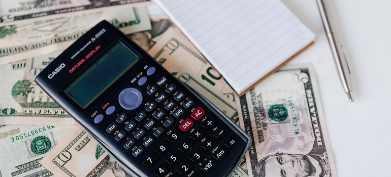 Pen, paper, calculator, and money