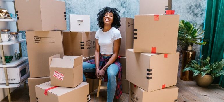 woman smiling because she hired one of the best long-distance moving companies Hamilton has