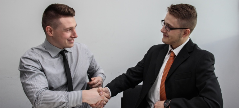 Two men shaking hands after an interview