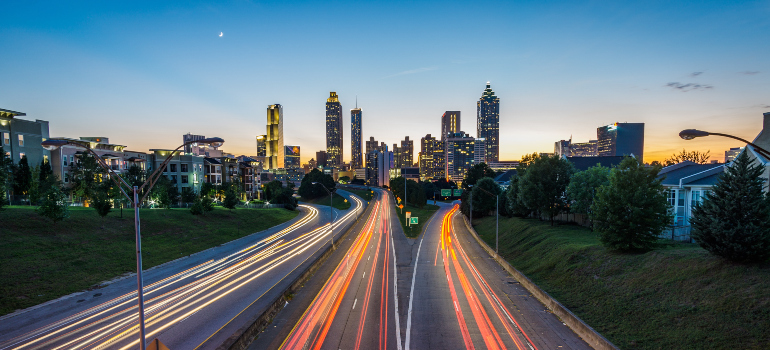 A photo taken from a street bridge with Atlanta skyline in the background.