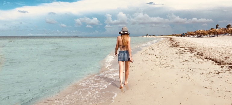 a woman walking on the beach