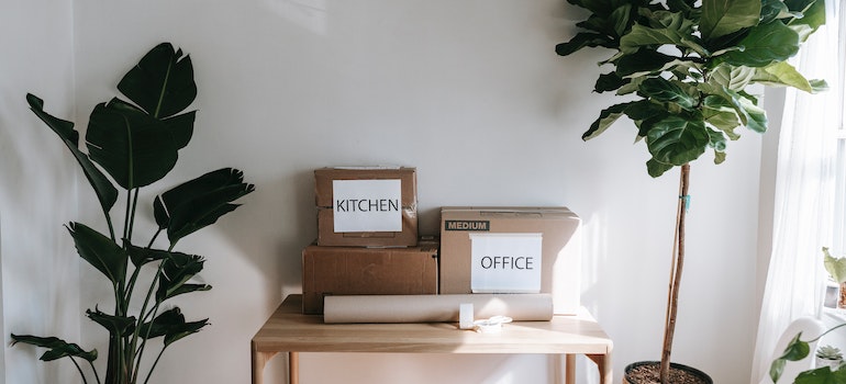 Two moving boxes labeled office and kitchen