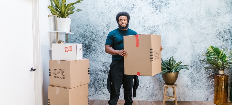 a movers holding a box 
