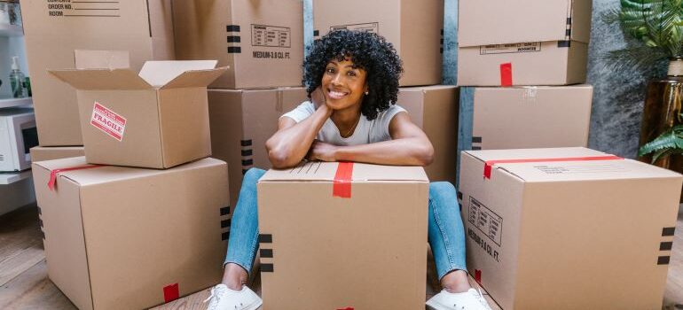 woman surrounded by moving boxes