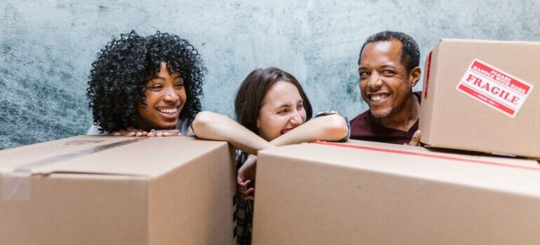 three people with moving boxes 