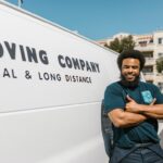 A man standing next to a moving van