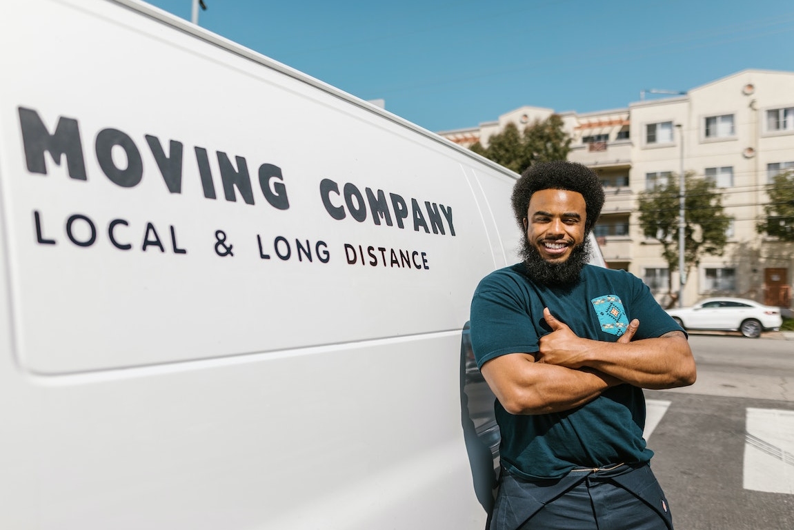 A man standing next to a moving van