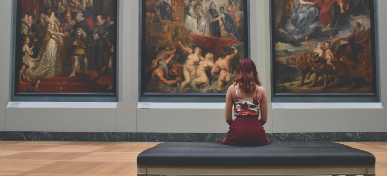 person watching paintings in the museums