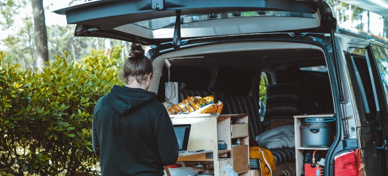 A person loading items into a van
