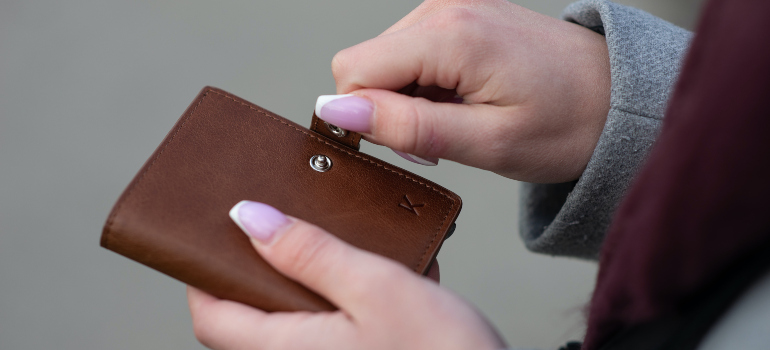 A woman closing a wallet.