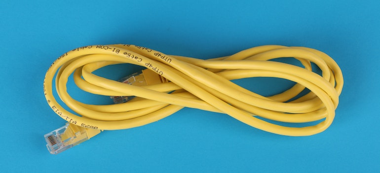 yellow ethernet cable representing the need to set up interent at your nerw home
