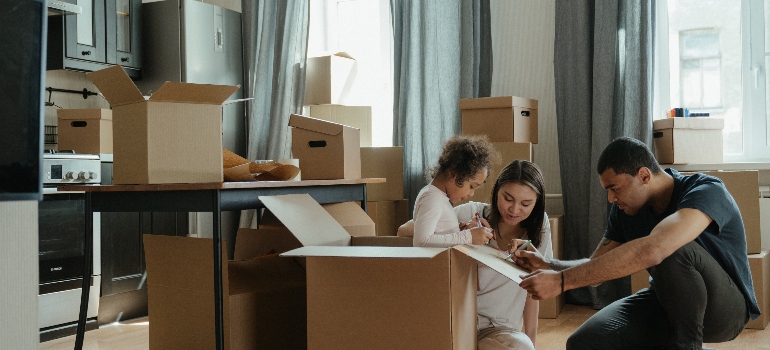 a family drawing on moving boxes before moving to one of the top places for families in Illinois