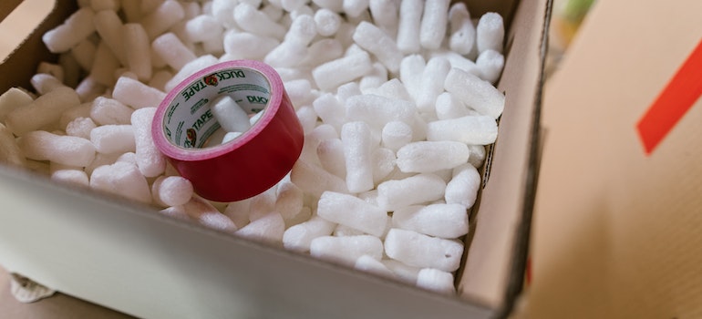 A red packing tape in a carton box.