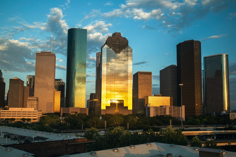 Buildings in Houston reflecting the light of the sunset.