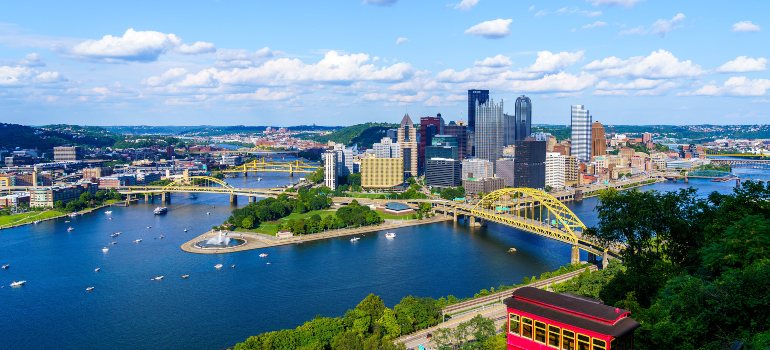 A waterfront photo of Pittsburgh during a sunny day 