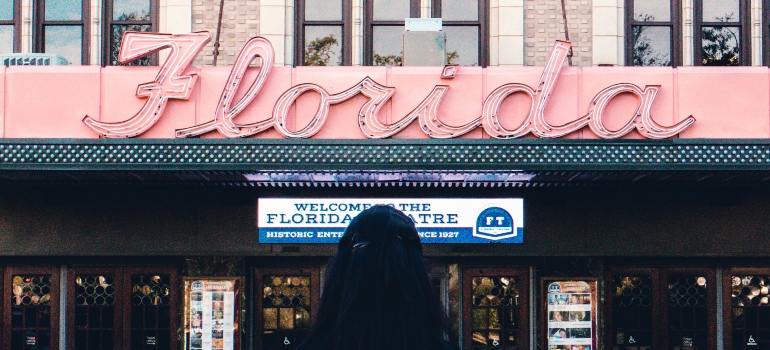 girl standing in front of the Florida sign