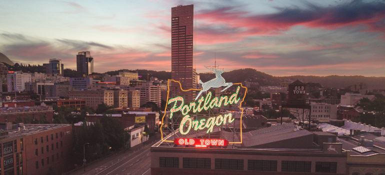 A sign that says Portland Oregon on the top of the building.