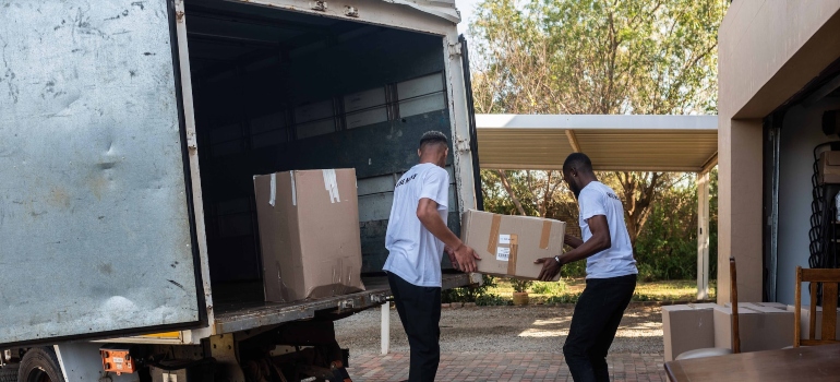 Two movers carrying a box