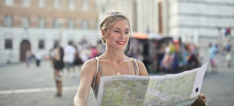A woman looking at a map in the city