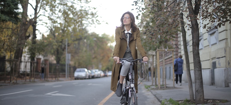 A woman driving a bicycle on the street.