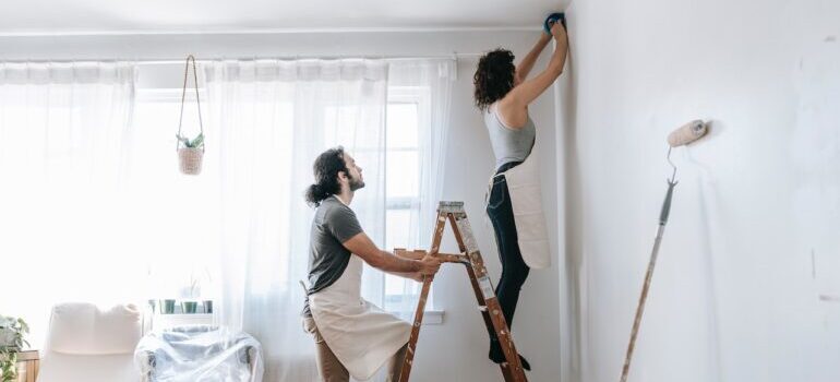 Couple painting their new house