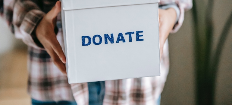 A woman holding a donate box