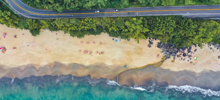 A road next to a beach photographed from air.