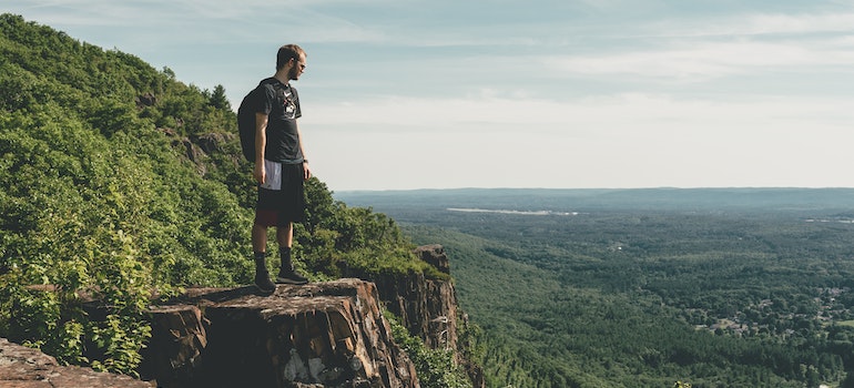 A man standing on the cliff in Massachusetts.