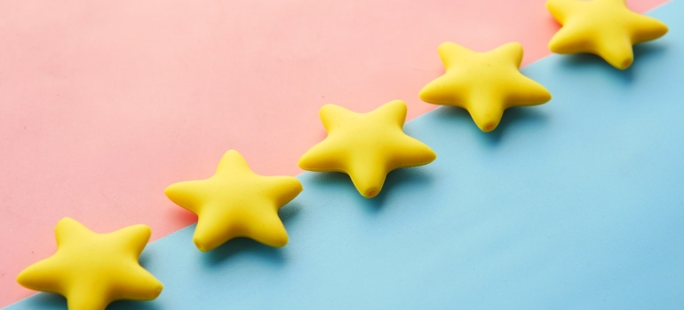 five yellow stars on pink blue background