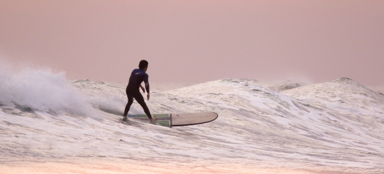 a man surfing after moving from California to Hawaii