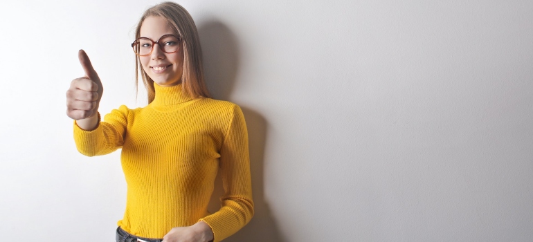 smlling young woman dressed in yellow turtleneck shirt
