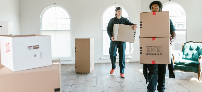 Movers carrying boxes will make dealing with damages after the move simpler